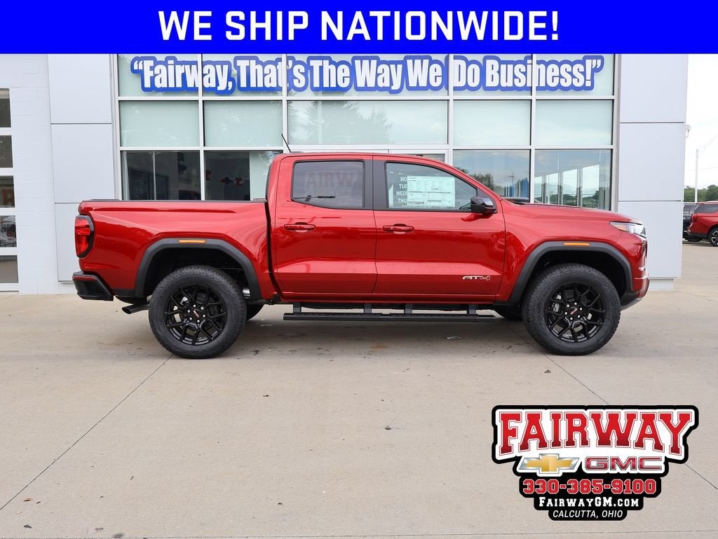 2026 GMC Canyon AT4 in Volcanic Red Tintcoat — front three-quarter view
